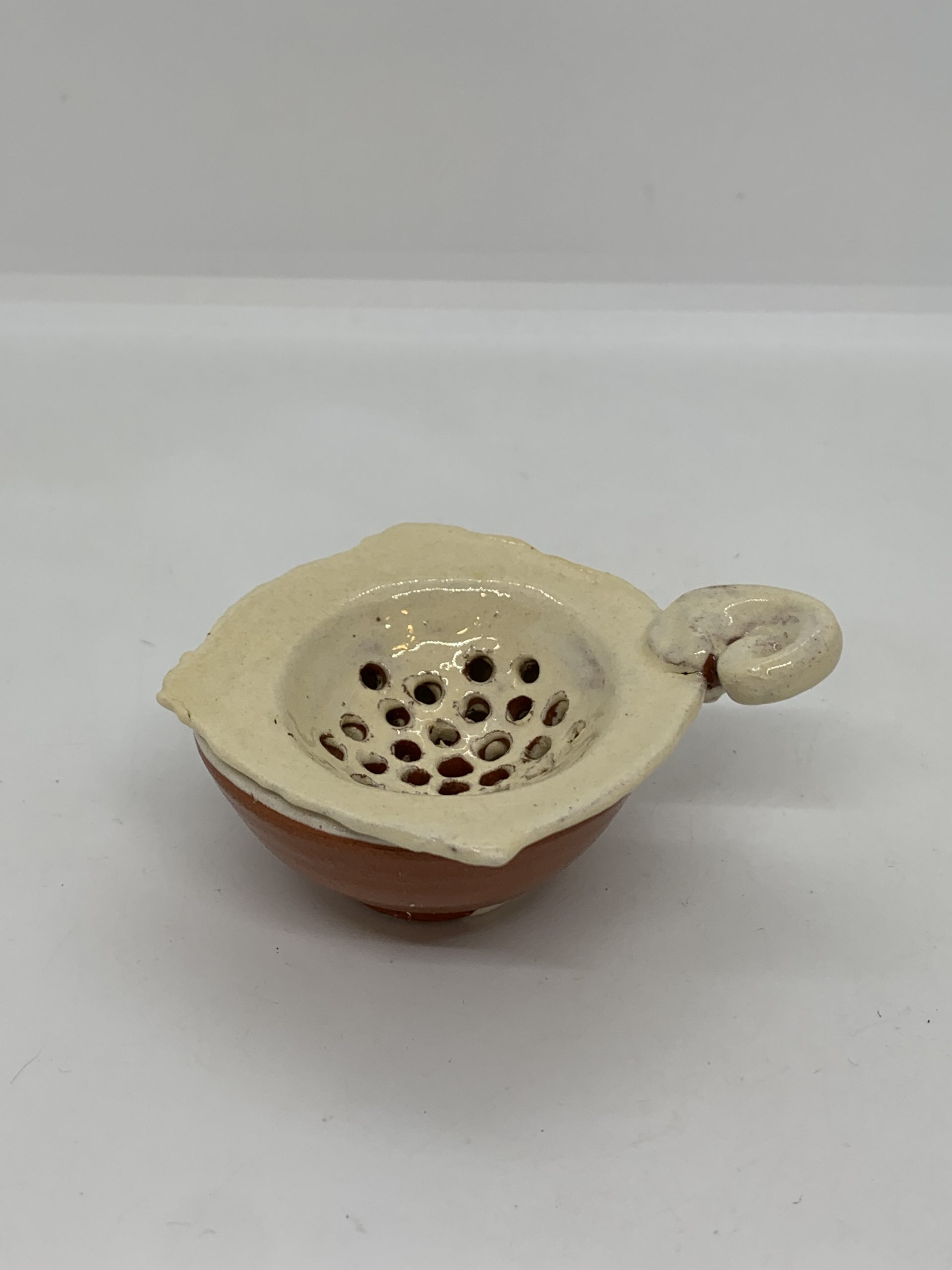 Hand Formed Pottery Tea Strainer and Base marked 6cm wide